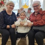 Wnuczka z babciami w trakcie poczęstunku.